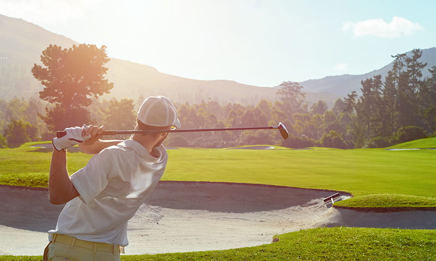Golfer hitting a ball on a golf course