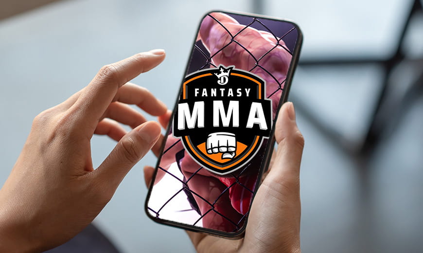 Hand holding a cell phone with DraftKings fantasy MMA logo on screen