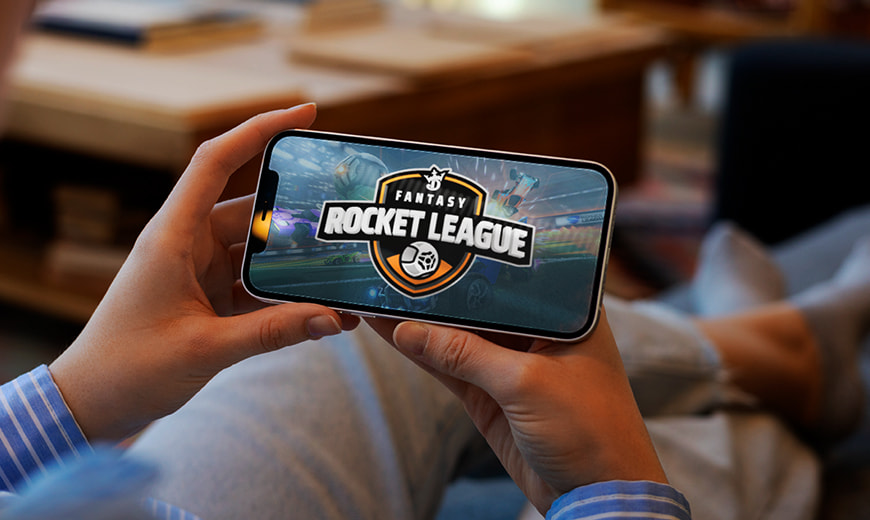 Person holding phone with fantasy Rocket League on screen